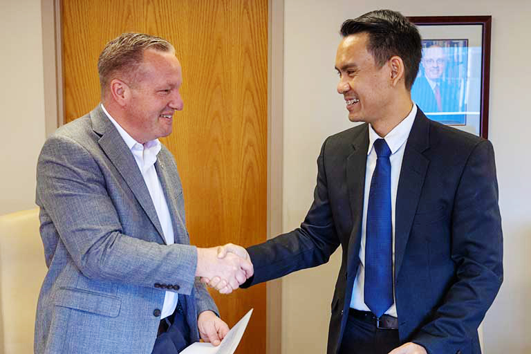 Men in suits shake hands