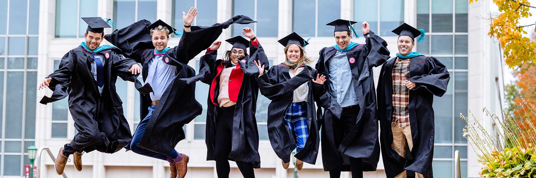 Grads in robes jump